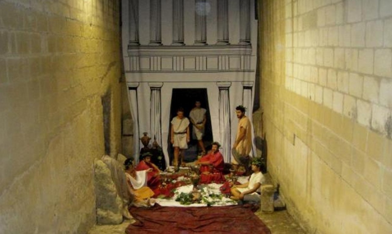 A funeral ceremony in front of a hypogeum