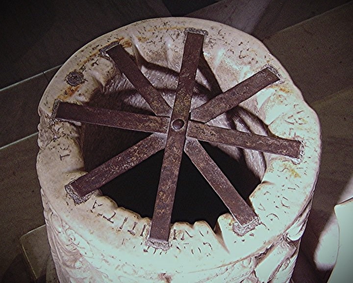 The ropes used to draw water leave visible marks at the top of the well, which have made the writing unreadable.