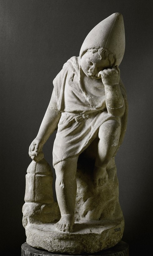 Statuette of a sleeping child (Cucullus) with a lamp. White marble. 1st-2nd Century A.D. Rome, Tiber (Palatine Bridge). National Roman Museum (Baths of Diocletian). Rome. Italy.