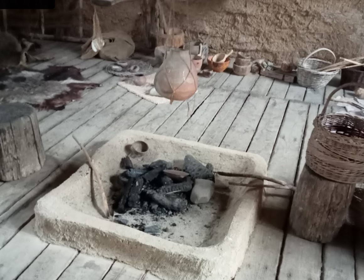 Interior of a Neolithic hut, the brazier in the foreground